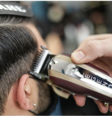 barber using wahl legend clipper cutting hair